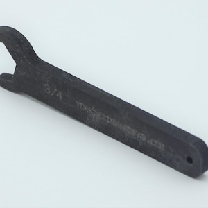 May include: A black 3/4 inch wrench with a rounded handle. The wrench is made of metal and has a textured surface.