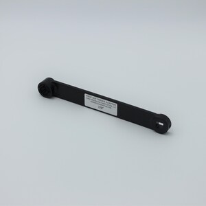 May include: Black plastic wrench adapter for a 1 1/8" nut. The adapter is labeled "Proof Nut Torque Adapter".