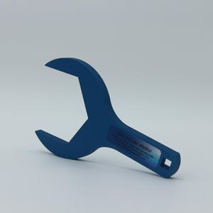 May include: A blue wrench with a square opening at the end of the handle. The wrench is labeled "2-1/2" INCH WRENCH".
