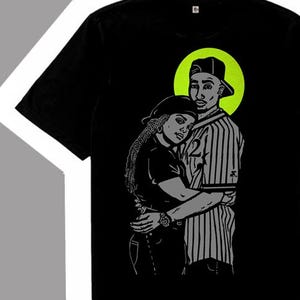 May include: A black t-shirt featuring a graphic illustration of two people embracing, with a lime green circular accent behind the figures. Below the shirt is a single grey and black sneaker with lime green accents and the text etsy.com/shop/Recipracol.