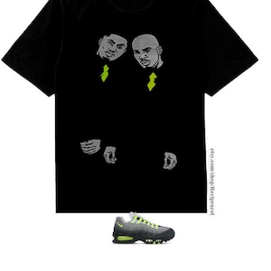 May include: Black t-shirt featuring a graphic of two men in suits with green ties. The text "etsy.com/shop/Recipracol" is printed on the bottom right of the shirt. A pair of grey and green trainers are also pictured.