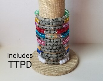 Sets von 12 Freundschaftsbändern, Perlen T Swift Armbänder, Eras Tour Freundschaftsbänder, austauschbare Konzertbänder, einschließlich TTPD