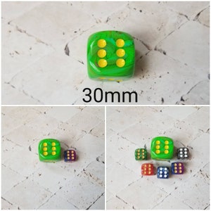 May include: A set of six green, yellow, red, blue, and black dice with white dots. The dice are 30mm in size.