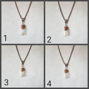 May include: Four silver necklaces with a small glass vial pendant. Each vial has a cork stopper and contains a small amount of white material.
