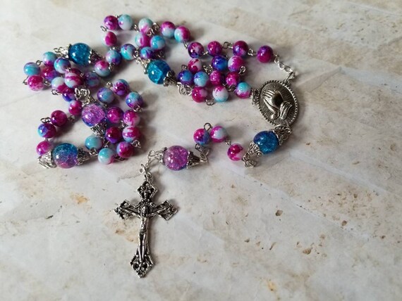 Five decade rosary, silver tone, pink and blue glass beads, praying hands center, detailed crucifix, religious, Catholic rosary, prayer bead