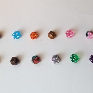 May include: Ten 20-sided dice in various colors and finishes, including clear, opaque, glitter, and metallic. The dice are arranged in two rows of five.