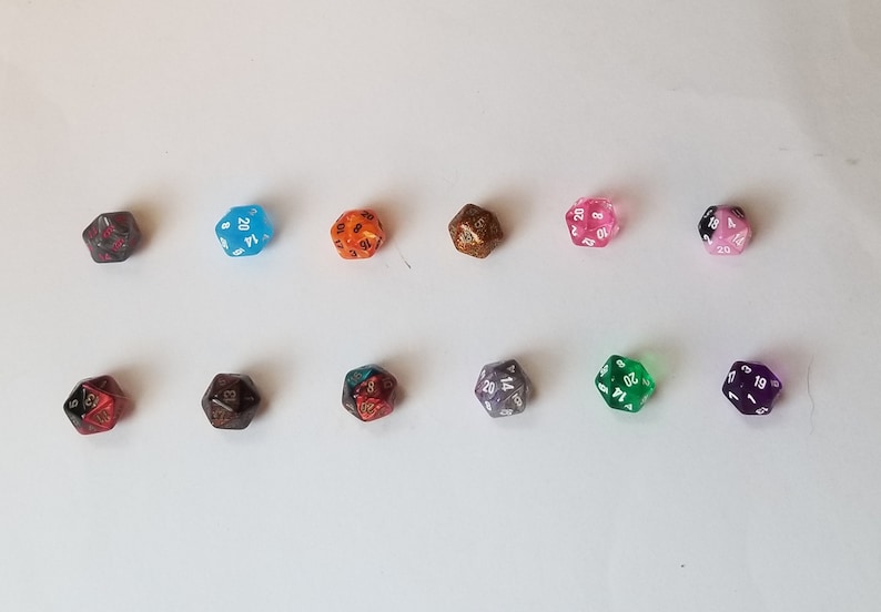 May include: Ten 20-sided dice in various colors and finishes, including clear, opaque, glitter, and metallic. The dice are arranged in two rows of five.