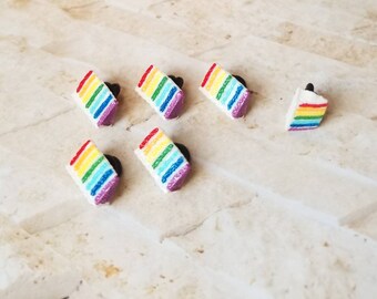Pin backs, hat pins, lapel pins, pinbacks, Pride pins, pride pinbacks, LGBTQ pinbacks, rainbow cake pinbacks, rainbow cake pins