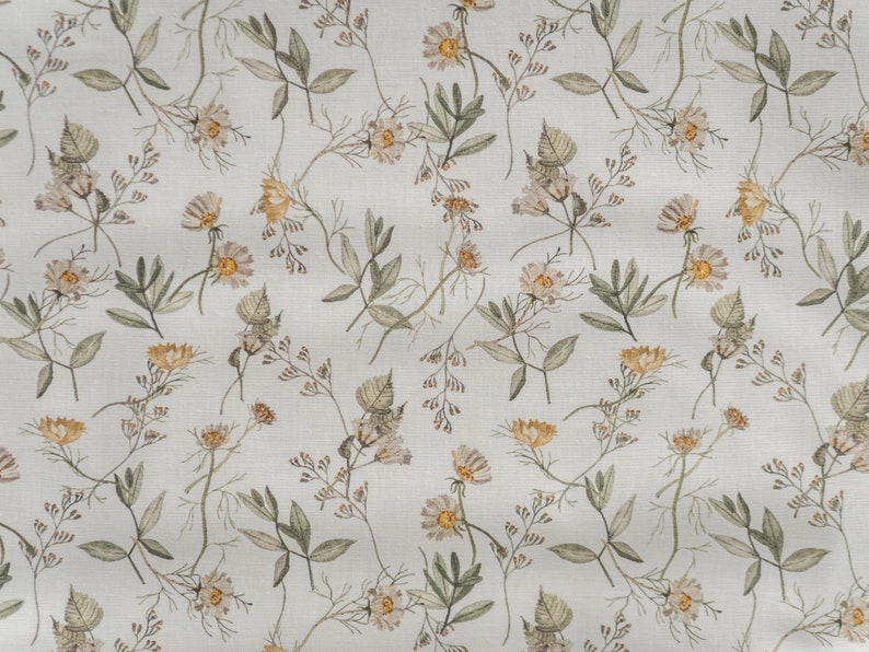 May include: A seamless pattern featuring a repeating design of small white and yellow flowers with green leaves on a light gray background.
