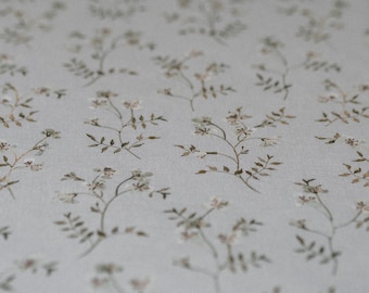 May include: A white background with a repeating pattern of small brown floral sprigs.