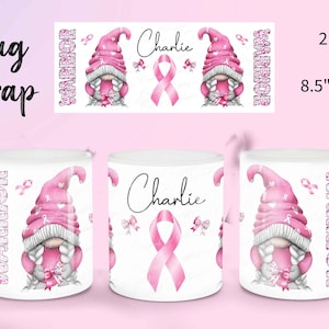 May include: White ceramic mug wrap featuring a pink gnome with a pink ribbon and the word "Warrior". The mug design includes the name "Charlie" and pink ribbon graphics. The image also shows a mug wrap design that is 21.6cm x 8.9cm.