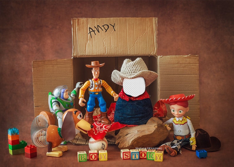 May include: Toy Story characters, including Woody, Buzz Lightyear, and Jessie, are arranged inside a cardboard box labeled "ANDY". The box is surrounded by colorful building blocks and a wooden sign that reads "BOY STORY".