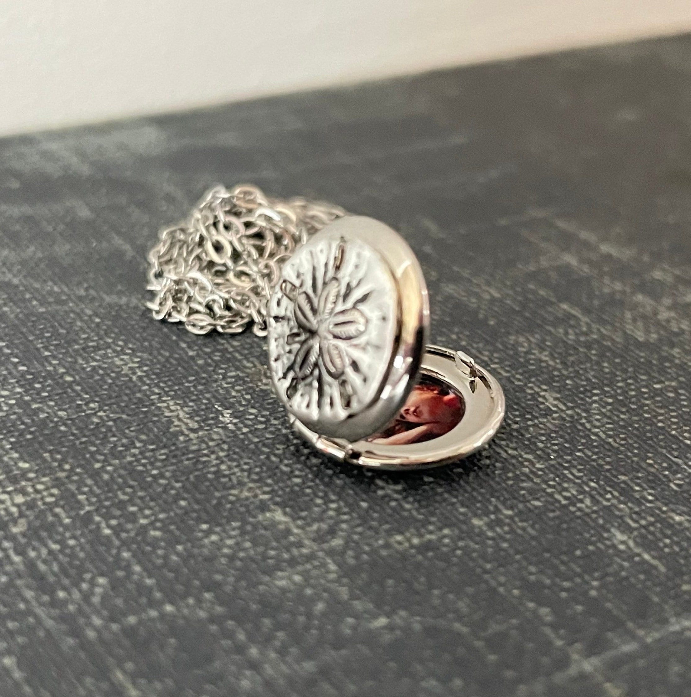 Petite silver sand dollar locket with photos