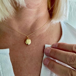 Tiny gold oval locket customized with photos minimalist and petite image 1