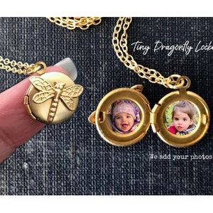 May include: Gold locket necklace with a dragonfly design. The locket opens to reveal two small photo spaces. The text "Tiny Dragonfly Locket" and "We add your photos" are visible in the image.