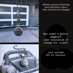 May include: A silver globe keychain with a chain attached. The keychain is hanging from a rear view mirror in a car. The text "Why order a mirror dangler? Less likelyhood of losing the locket!" is visible in the image. The text "your options are at checkout" is also visible in the image.