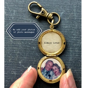 May include: Gold locket keychain with a photo of an older couple inside. The locket is open and the inside reads "Always Loved".