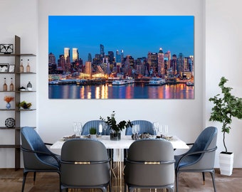 May include: A large canvas print of a cityscape at dusk. The image features a skyline of tall buildings with illuminated windows reflecting in the water below. The sky is a deep blue, and the overall scene is vibrant and colorful.
