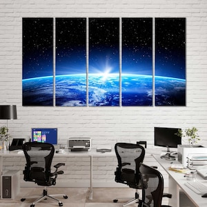 May include: A multi-panel canvas print depicting a sunrise over Earth from space. The image shows a blue and green planet with a bright sun shining in the distance. The background is a dark blue with stars visible.