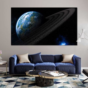 May include: A blue and green planet with a ring of stars around it, set against a black background with a blue nebula in the distance.