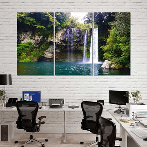 May include: A three-panel canvas print featuring a waterfall cascading down a rocky cliffside, surrounded by lush green foliage. The water is a vibrant blue, and the scene is tranquil and serene.