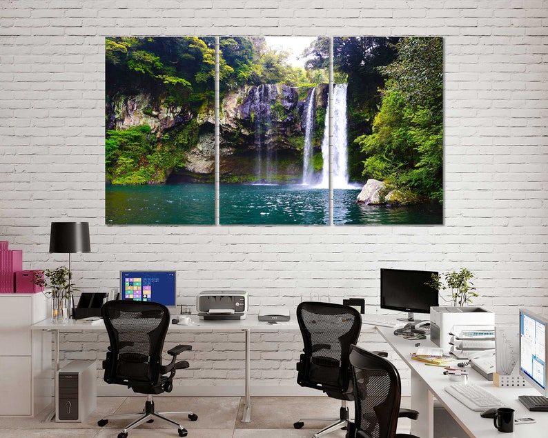 May include: A three-panel canvas print featuring a waterfall cascading down a rocky cliffside, surrounded by lush green foliage. The water is a vibrant blue, and the scene is tranquil and serene.