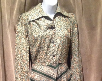 May include: A long-sleeved dress with a floral print and a striped skirt. The dress has a button-up front and a ruffled hem.