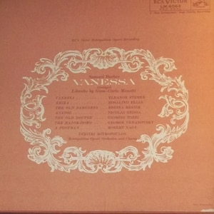 May include: A vintage record album cover with a salmon-colored background. The album features the opera "Vanessa" by Samuel Barber. White ornate text and design elements frame the title and cast list, including Eleanor Steber and Rosalind Elias. The RCA Victor logo is visible.