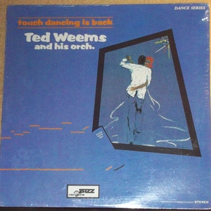 May include: A blue vinyl record album cover with a picture of a couple dancing. The album is titled "Touch Dancing is Back" by Ted Weems and his orchestra. The album cover is part of a dance series.