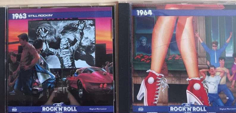 May include: Two CD cases featuring retro album art. One case is labeled "1963 Still Rockin'" with a monster graphic and a red car. The other is labeled "1964" with legs in red high-top sneakers. Both cases have "The Rock 'N' Roll Era" text.