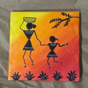 May include: Square ceramic tile featuring a stylized painting of two figures against a gradient orange and red background. One figure carries a basket, and the other is running. Black silhouettes and green plant-like shapes are at the bottom.