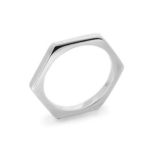 May include: A silver hexagonal ring with a smooth, polished finish.