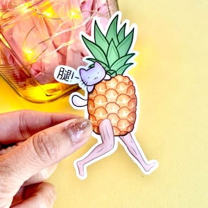 May include: A sticker of a purple cat wearing a pineapple costume. The cat is running and the pineapple has legs. The text "Run!" is written in Japanese on the sticker.