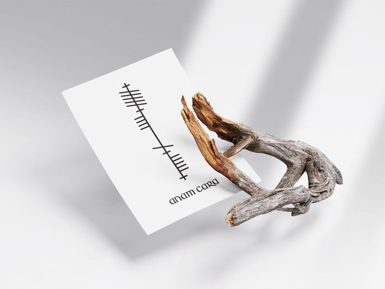 Side angle view of an Anam Cara (Soulmate) Ogham print with black Ogham script and Anam Cara text on a clean white background, displayed beside a decorative branch.