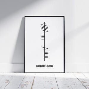 Anam Cara (Soulmate) text below Ogham script that translates to Anam Cara, Irish for Soulmate. Black Ogham lettering and text on a clean white modern background, displayed in an A4 black frame mock-up.