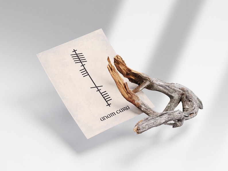 Side angle view of an Anam Cara (Soulmate) Ogham print with black Ogham script and Anam Cara text on an antique-style background, displayed beside a decorative branch.