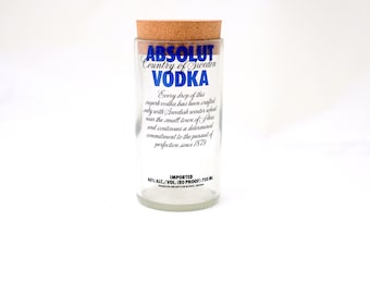 May include: A clear glass bottle with a cork top. The bottle is labeled "ABSOLUT Country of Sweden VODKA". The label also includes the text "Every drop of this superb vodka has been crafted only with Swedish winter wheat near the small town of Ahus and continues a determined commitment to the pursuit of perfection since 1879". The bottle is labeled "IMPORTED 40% ALC/VOL (80 PROOF) 750 ML".