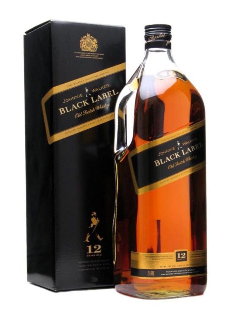 May include: A bottle of Johnnie Walker Black Label 12 year old blended Scotch whisky. The bottle is clear glass with a black label and gold lettering. The label features the Johnnie Walker logo and the words "Black Label" and "Old Scotch Whisky". The bottle is sitting on a white surface.