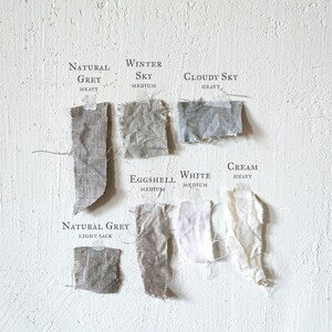 a white wall with a bunch of different types of paper on it