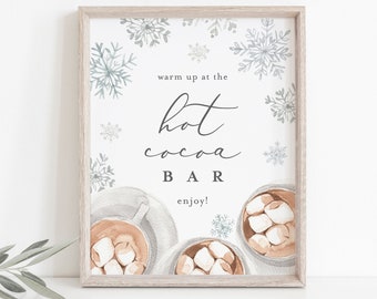 May include: A printable sign with a white background and blue snowflakes. The sign says "warm up at the hot cocoa bar enjoy!" and has a watercolor illustration of three mugs of hot cocoa with marshmallows.