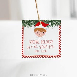 May include: A square gift tag with a red and white striped border and an elf illustration wearing a red hat. The tag reads "SPECIAL DELIVERY from the North Pole LOVE, CLYDE."