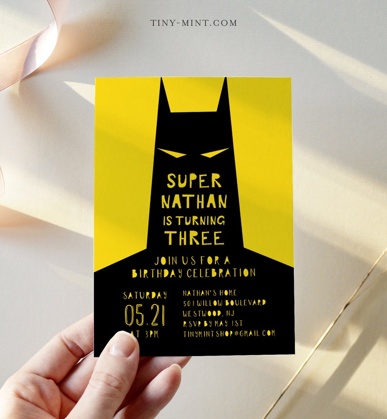 May include: A yellow and black birthday invitation with a Batman silhouette. The text reads "Super Nathan is turning Three. Join us for a birthday celebration. Saturday 05.21 at 3PM. Nathan's Home 501 Willow Boulevard Westwood, NJ RSVP by May 1st TinyMintShop@gmail.com"
