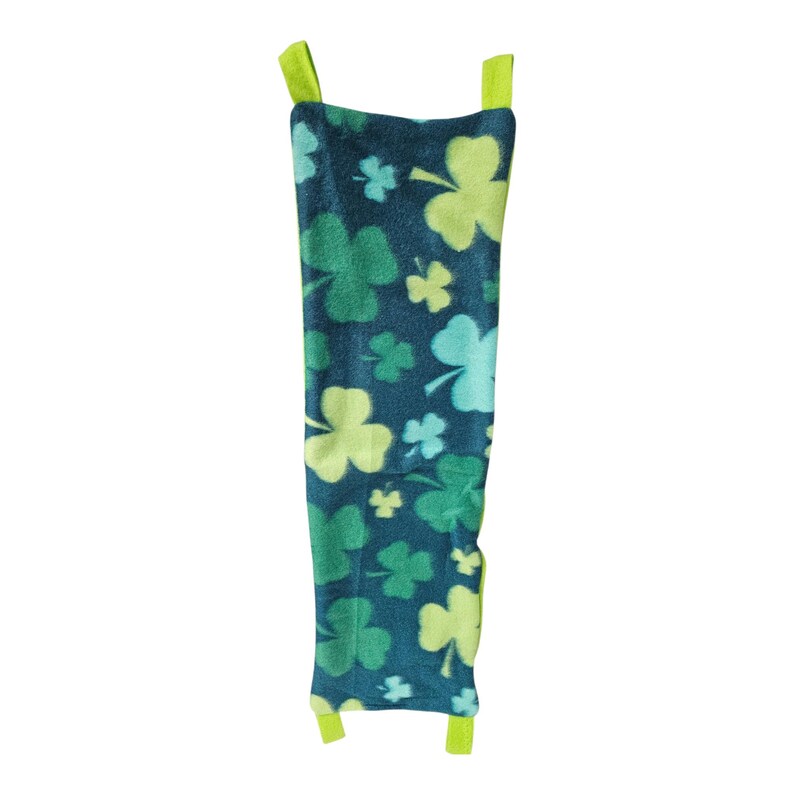 May include: A St. Patrick's Day themed pet accessory. The item is a dark teal fleece with a pattern of green and light green shamrocks. The accessory has two lime green straps at the top and bottom.