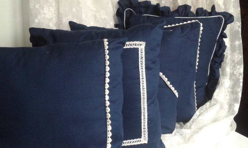 blue cushion with white embroidered days