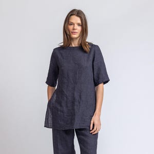May include: A dark blue linen tunic top with short sleeves and a relaxed fit, paired with matching wide-leg linen pants.