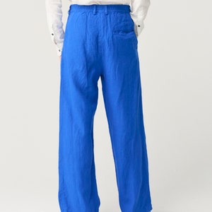 May include: A pair of wide-leg pants in a vibrant blue color. The pants have a relaxed fit and a drawstring waistband.