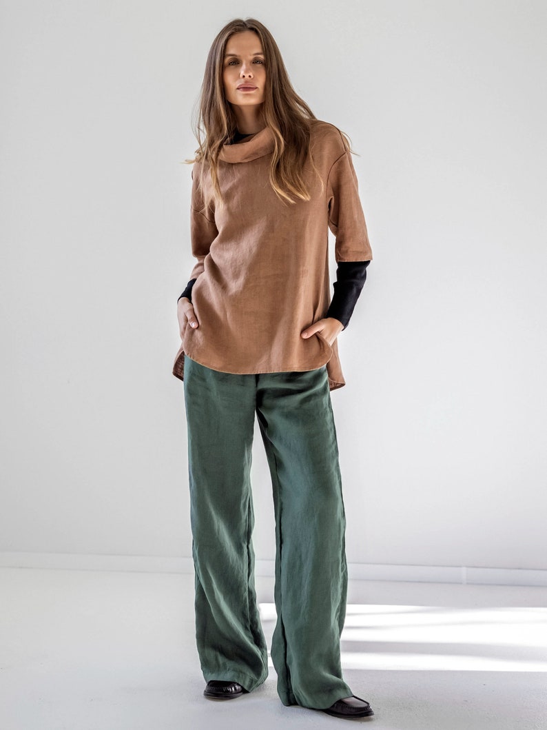 May include: A brown linen top with a cowl neck and a green linen pair of pants.