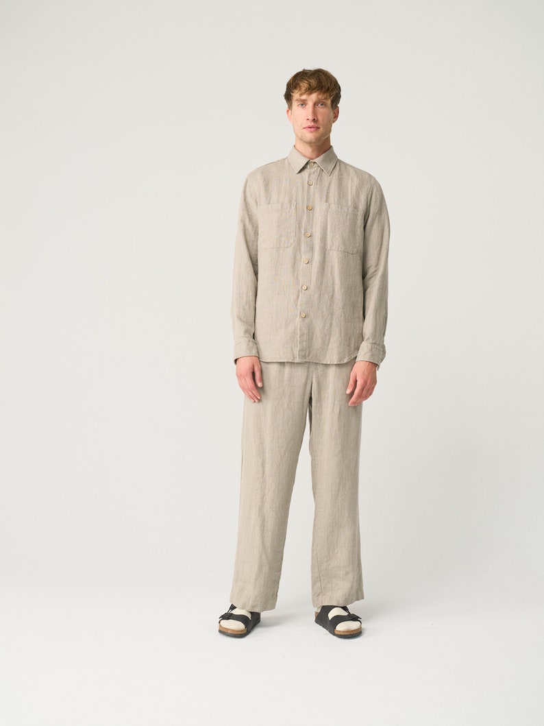 May include: A light brown linen shirt and matching pants. The shirt has a button-down collar and long sleeves. The pants have a straight leg.