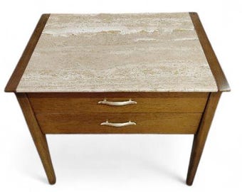 May include: A wooden nightstand with two drawers and a travertine top. The nightstand has a mid-century modern design and features brass drawer pulls.