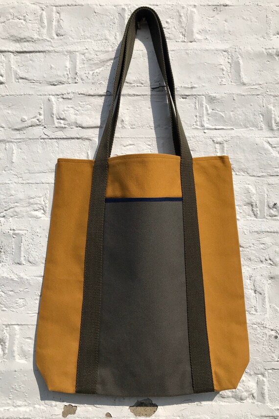 Tote bag. Mustard yellow canvas shopper bag with a deep front khaki green canvas pocket. 100% cotton.